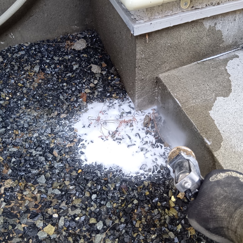 玄関周りに防蟻剤を散布する様子