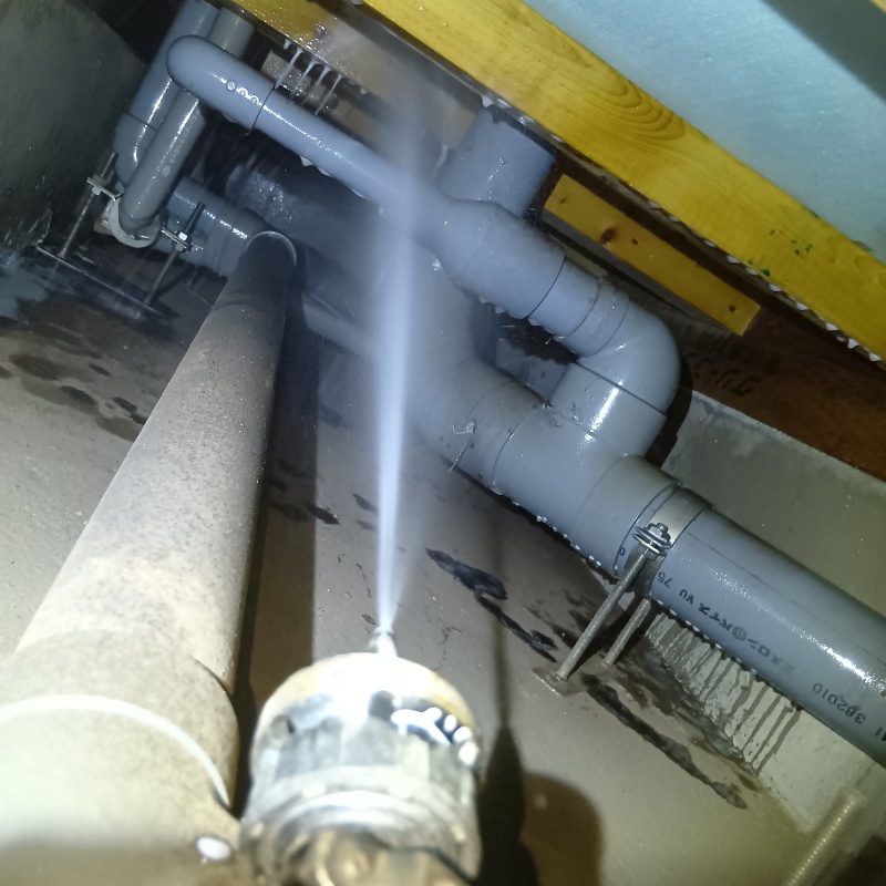 床下の木材に防蟻剤を吹きつけている様子