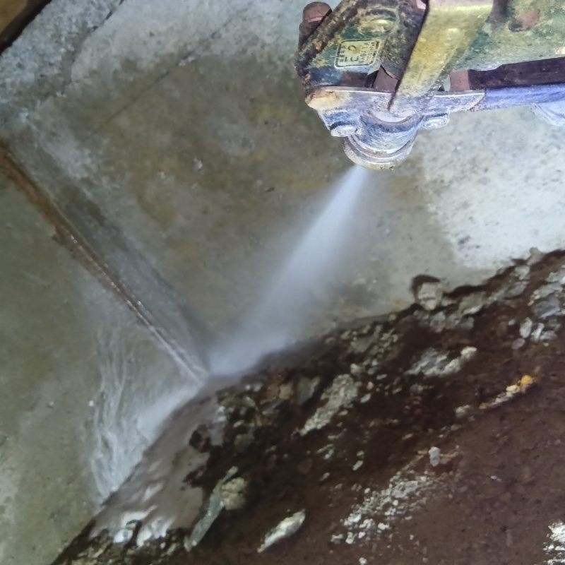 地面にシロアリ駆除剤を吹きつけている様子