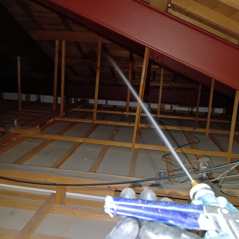 屋根裏の木材にシロアリ駆除剤を散布