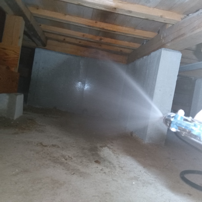 床下の基礎部分に防蟻剤を散布する様子