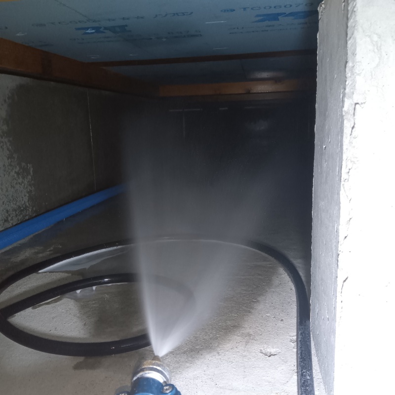 床下の土壌に防蟻剤を散布する様子