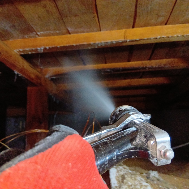 床下の木材にシロアリ駆除剤を散布する様子