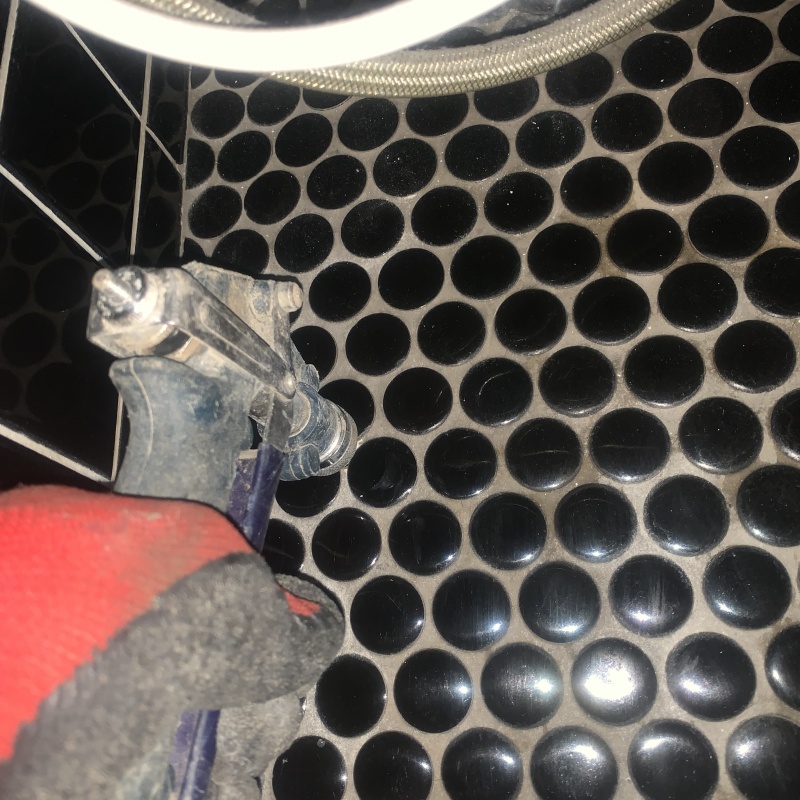 浴室の床にシロアリ駆除剤を注入する様子