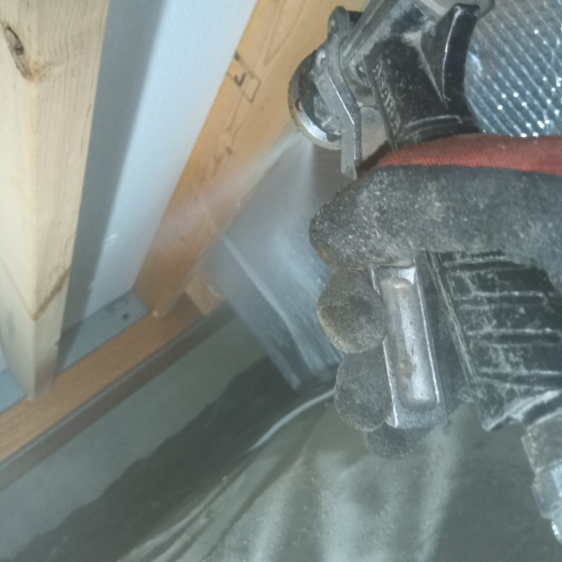 床下の木材にシロアリ駆除剤を散布する様子