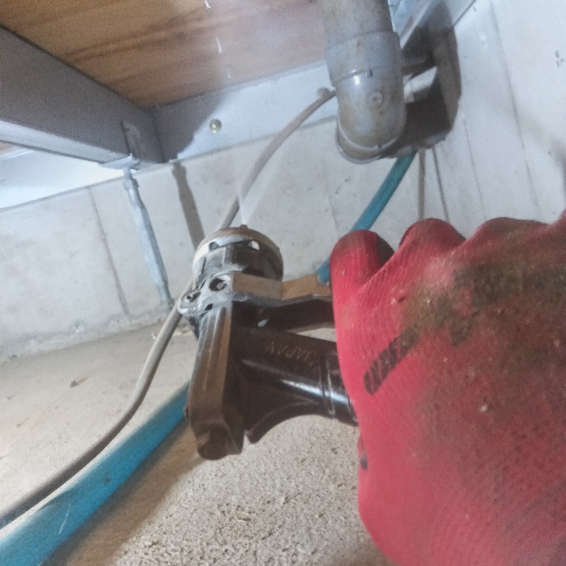 床下木材にシロアリ駆除剤を吹き付ける様子