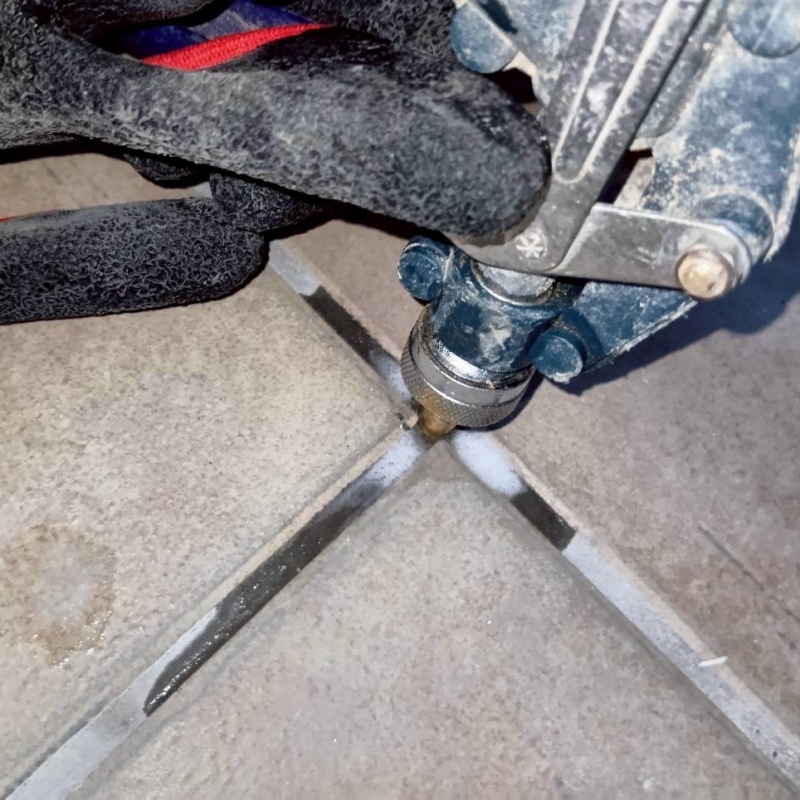 玄関床のタイルの目地からシロアリ駆除剤を注入