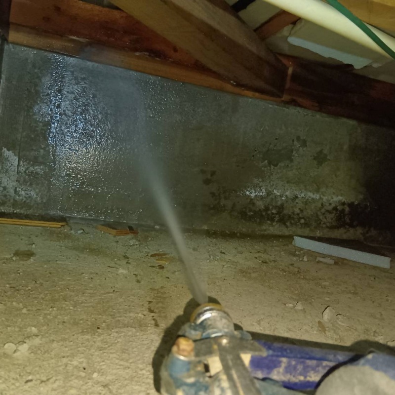 基礎にシロアリ駆除剤を吹き付ける様子