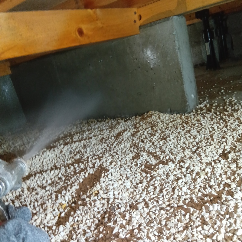 基礎に防蟻剤を吹きつける様子