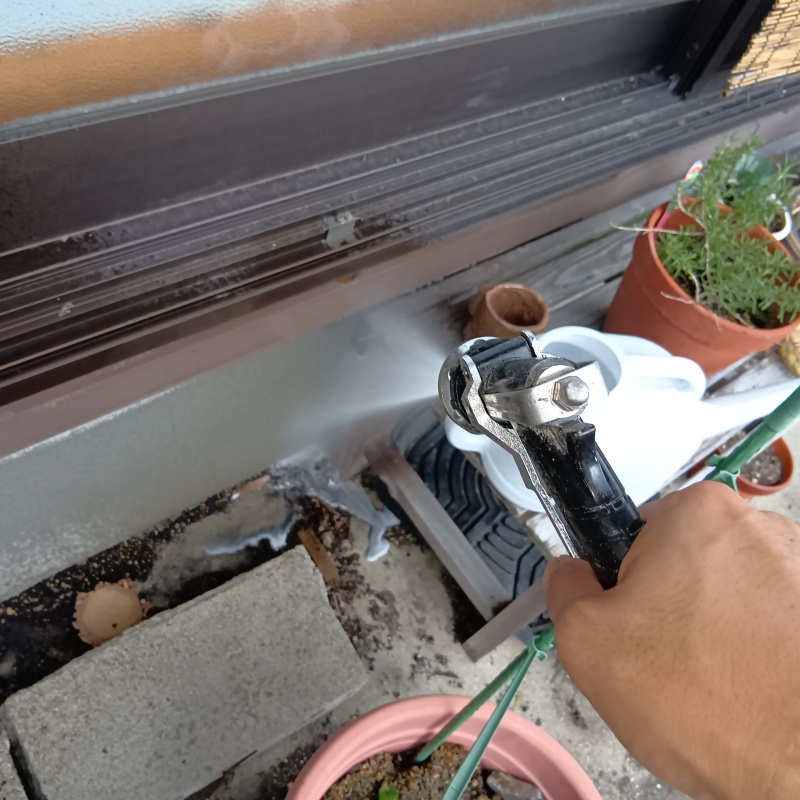 基礎まわりにシロアリ駆除剤を吹き付ける様子