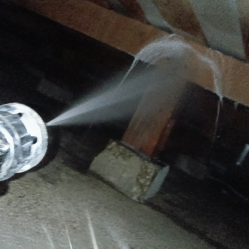 床下の木材に駆除剤を吹き付ける様子