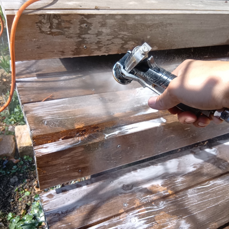 ウッドデッキにシロアリ駆除剤を散布している様子