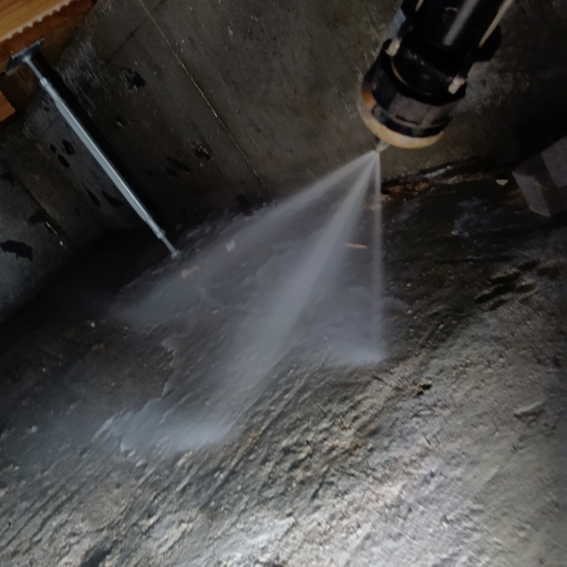 地面にシロアリ駆除剤を吹き付ける様子