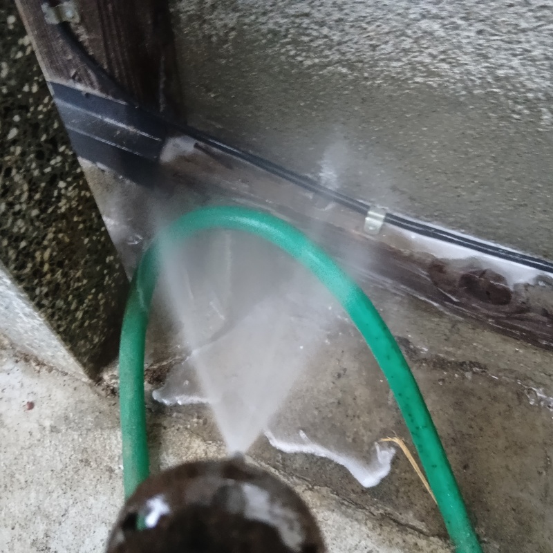 屋外の地面にシロアリ駆除剤を散布