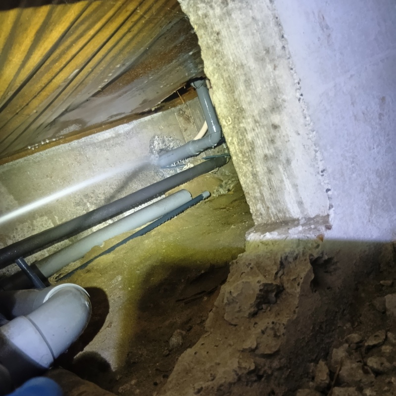 床下の基礎部分にシロアリ駆除剤を散布する様子