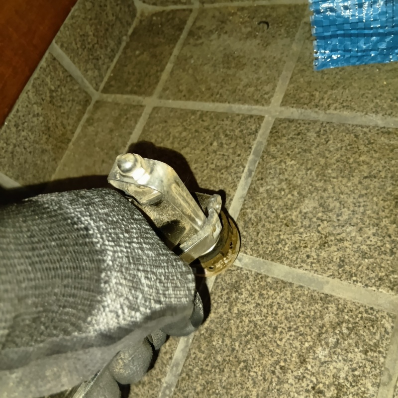 玄関の床にシロアリ駆除剤を注入する様子