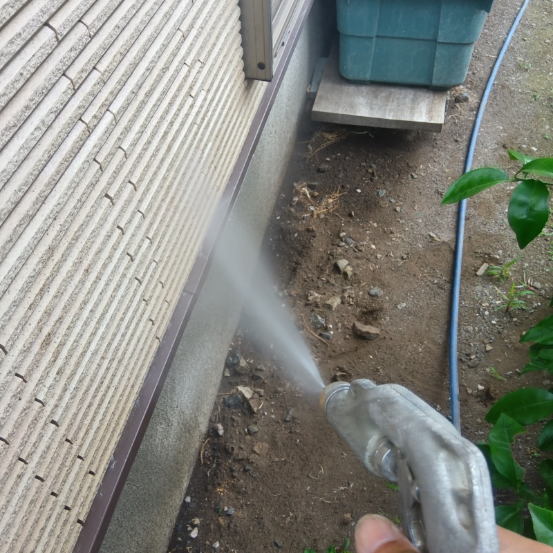 基礎まわりにシロアリ駆除剤を散布する様子