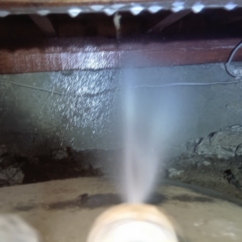 床下の基礎部分にシロアリ駆除剤を散布する様子