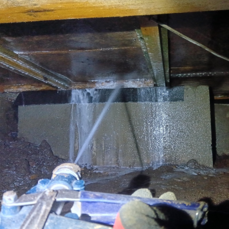 床下の木材にシロアリ駆除剤を散布する様子