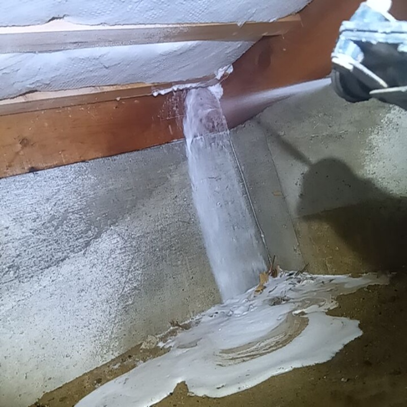 床下の木材にシロアリ駆除剤を吹きつける様子