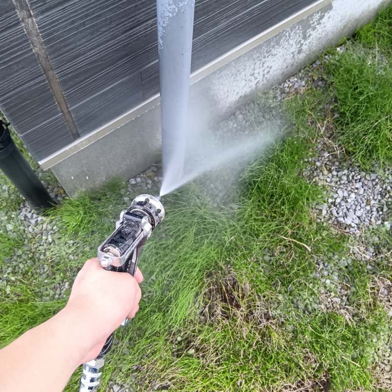 建物外周の土壌に防蟻剤を吹き付ける様子