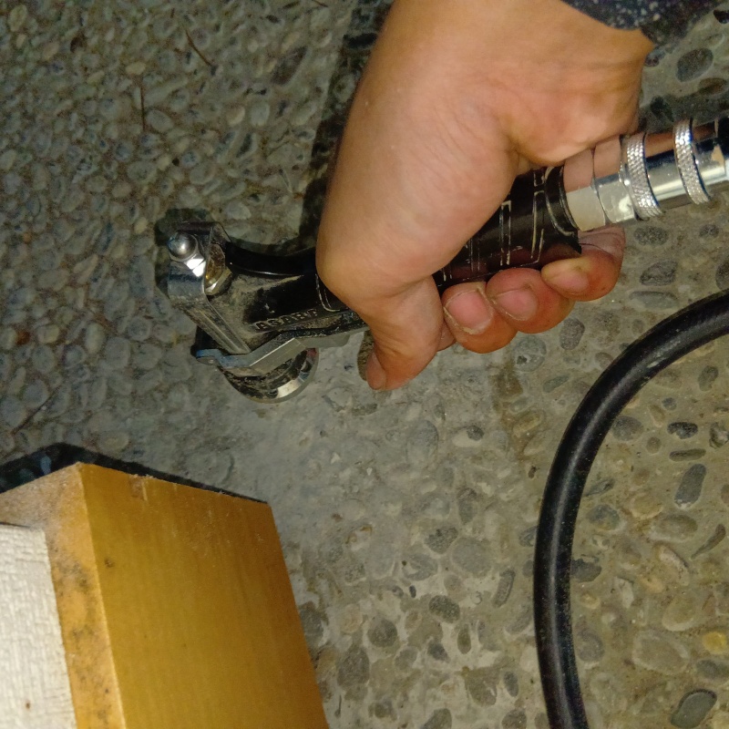 玄関の床にシロアリ駆除剤を注入する様子