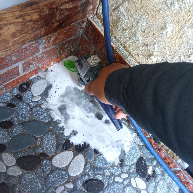 玄関の床にシロアリ駆除剤を注入する様子