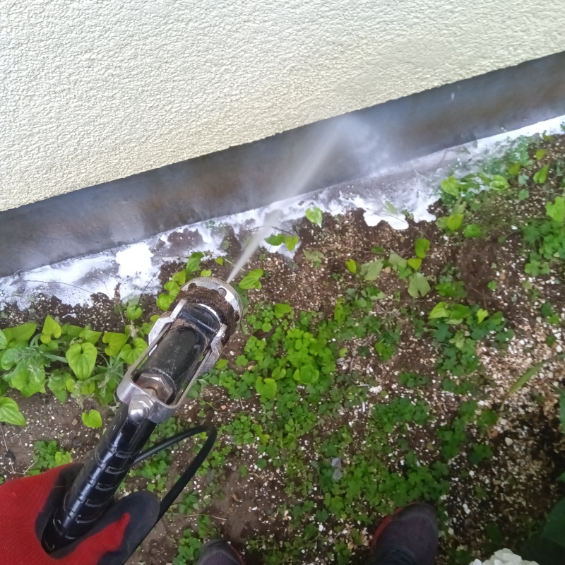 基礎まわりにシロアリ駆除剤を散布する様子