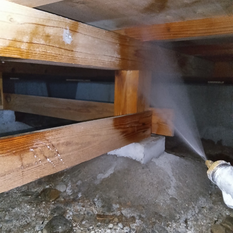 床下の木材に防蟻剤を散布する様子