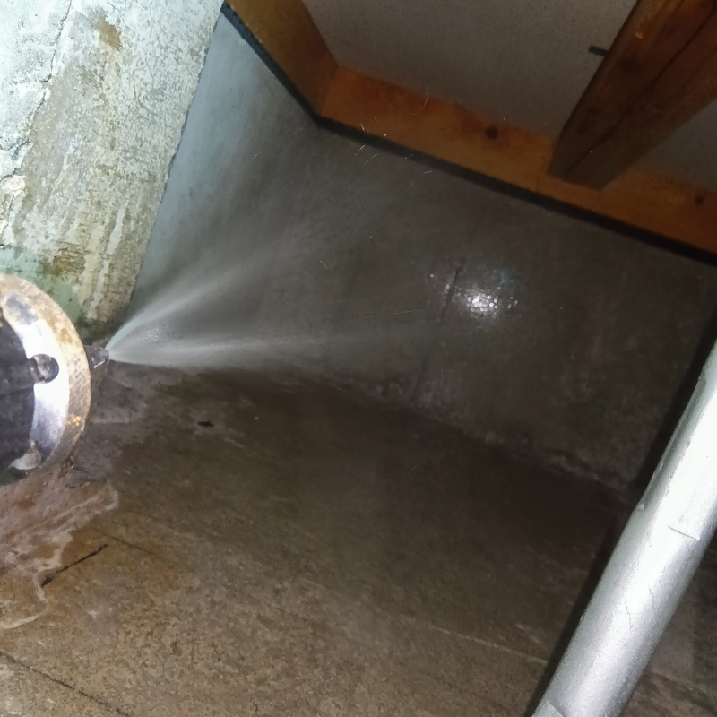 床下の基礎部分にシロアリ駆除剤を散布する様子