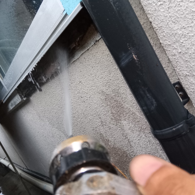窓下の外壁にシロアリ駆除剤を散布