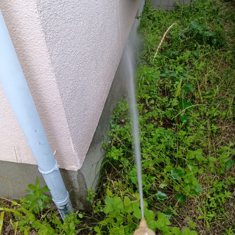 建物外周の土壌に防蟻剤を吹き付ける様子