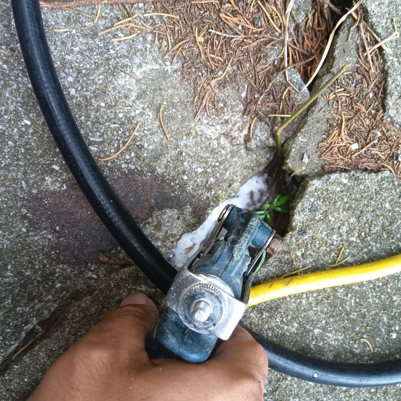 屋外の地面にシロアリ駆除剤を散布