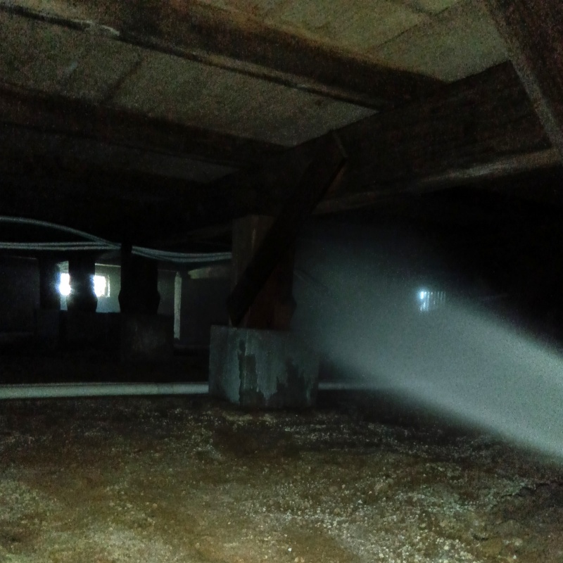 床下木材に防蟻剤を吹き付ける様子