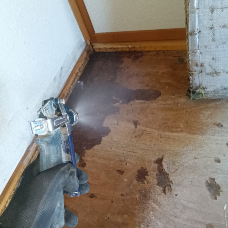 屋内の床にシロアリ駆除剤を散布