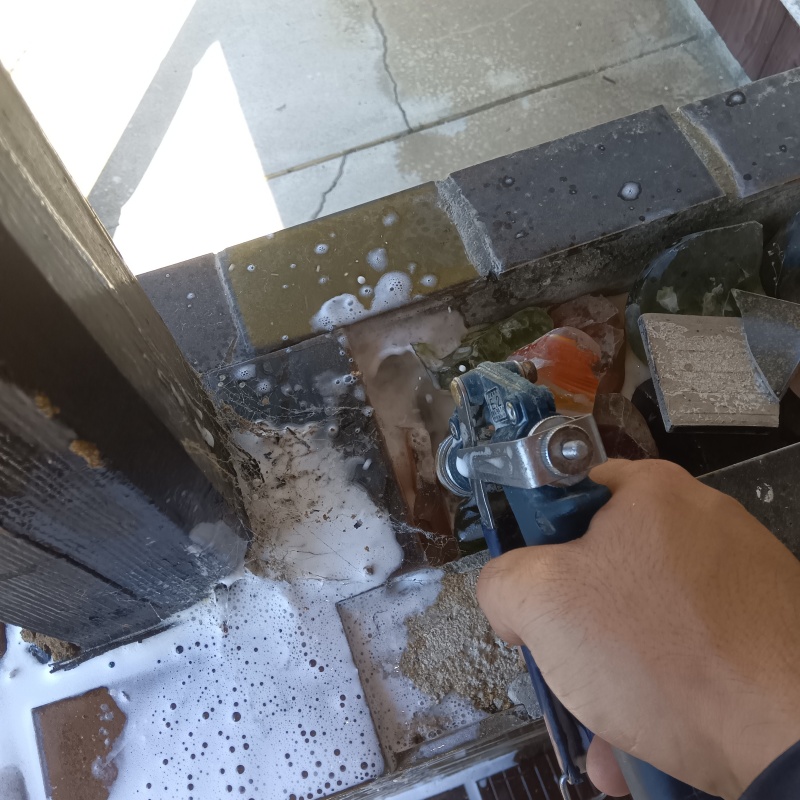 玄関の床にシロアリ駆除を注入する様子