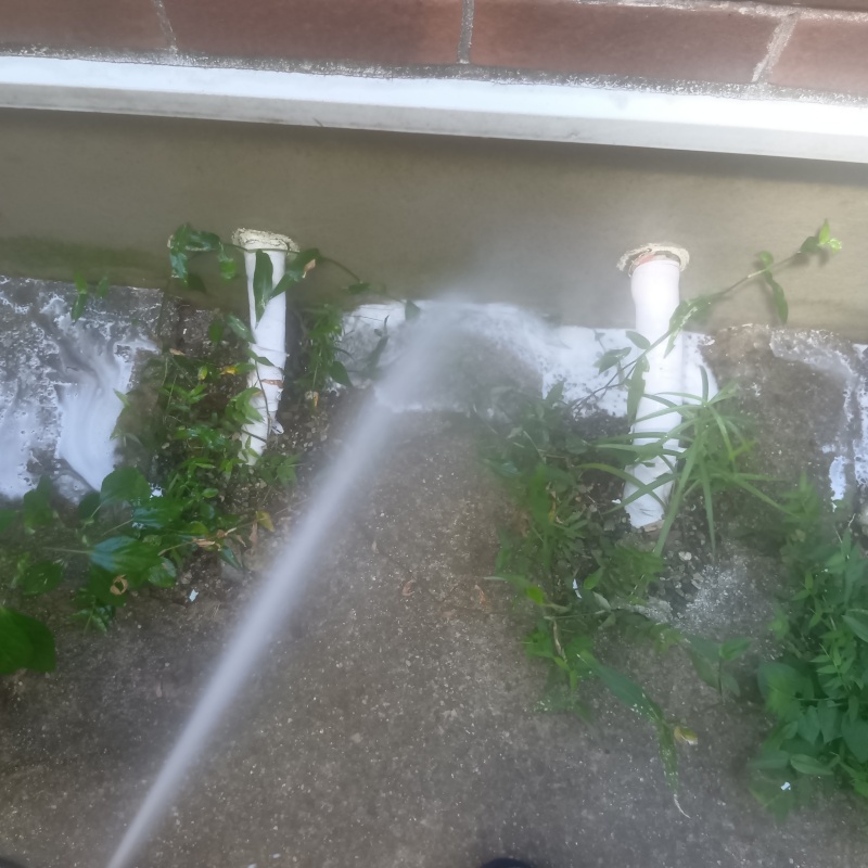 基礎まわりにシロアリ駆除を散布する様子