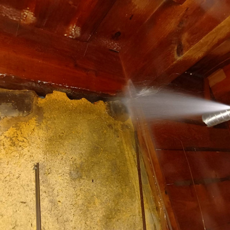 床下の木材にシロアリ駆除剤を散布する様子