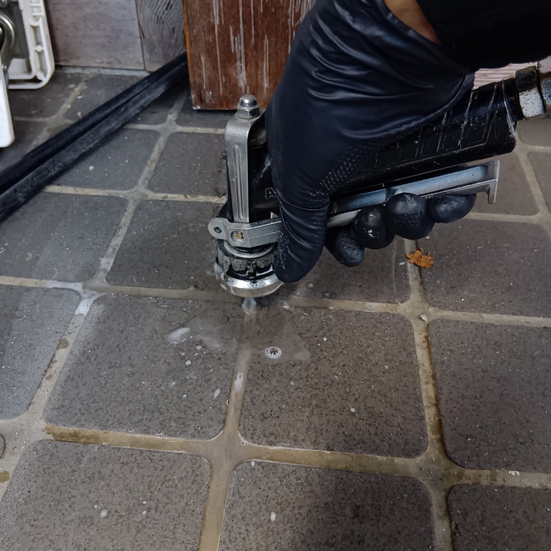 玄関の床に防蟻剤を注入する様子