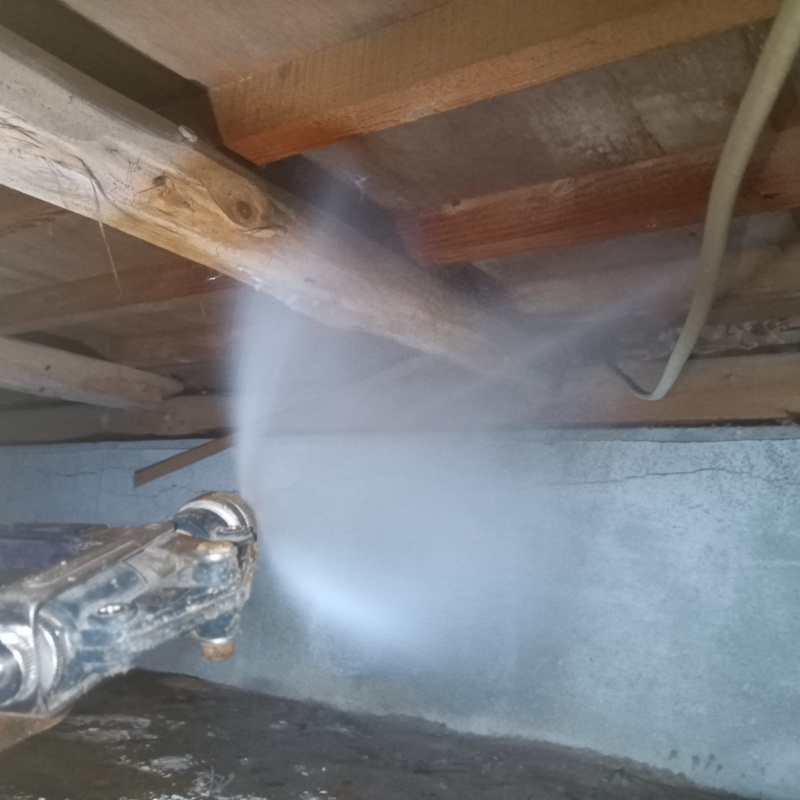 床下の木材に防蟻剤を散布する様子