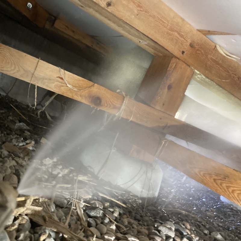 床下の木材にシロアリ駆除剤を散布する様子