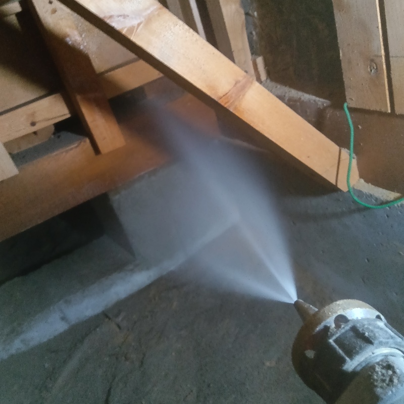 床下の木材にシロアリ駆除剤を散布する様子