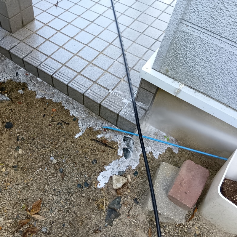 基礎まわりにシロアリ駆除剤を散布する様子