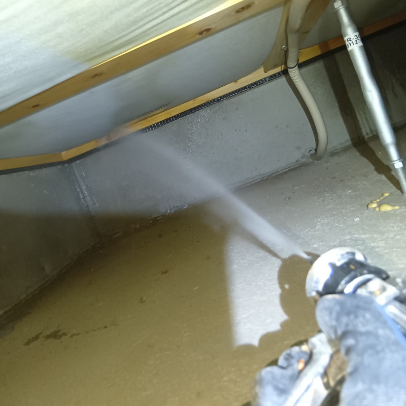 床下の木材にシロアリ駆除剤を散布する様子